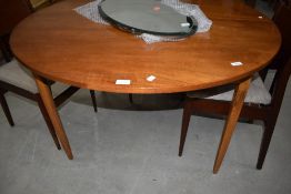 A vintage sapele circular dining table, diameter approx. 122cm, additional leaf approx. 59cm