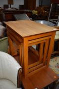 A vintage nest of three tables, teak effect