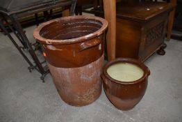 A traditional crock pot, height approx. 41cm and similar smaller
