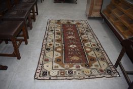 A traditional Turkeman or similar rug having cream ground, approx. 210 x 116cm