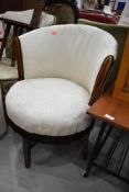 An Edwardian mahogany and inlaid low seat circular club chair with later upholstery