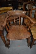 An early 20th Century oak spindle back elbow chair