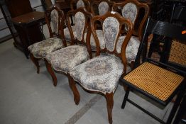 A set of six continental style dining chairs having mahogany frames, upholstered seats and backs