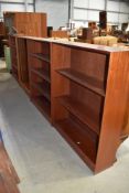 A set of four teak/sapele open book shelves, two labelled Herbert Gibbs, dimensions for each approx.