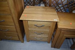 A modern golden oak side chest of three low drawers, dimensions approx. W50cm D40cm H57cm
