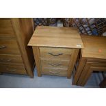 A modern golden oak side chest of three low drawers, dimensions approx. W50cm D40cm H57cm