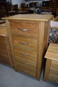 A modern golden oak narrow chest of five drawers, dimensions approx. W58cm D42cm H103cm