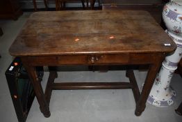 An antique cottage farm house side table in a provincial French design having chamfered and pegged