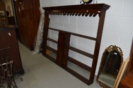 A period oak dresser back, havimg 'wave' canopy, open shelves and central narrow cupboard, width