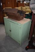 A vintage side cabinet, contains a selection of tools and a cantilever tool box