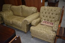 A nice quality modern three piece suite comprising settee and two armchairs having large brass