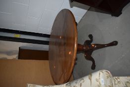 An antique style circular table having once been a tilt top, cut down to coffee table size