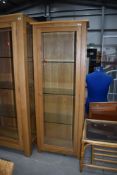 A modern golden oak glazed display cabinet, approx. W65cm D35cm H170cm