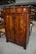 A late Victorian mahogany side cabinet having shaped top (gallery removed) over frieze drawer and