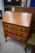An early to mid 20th Century walnut bureau on ball and claw feet, width approx. 74cm
