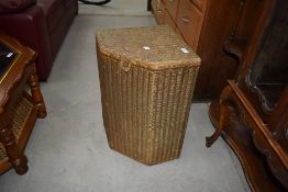 A vintage Lloyd loom corner linen basket of small proportions