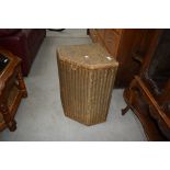 A vintage Lloyd loom corner linen basket of small proportions