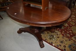 A Victorian mahogany oval dining table on quadruple base