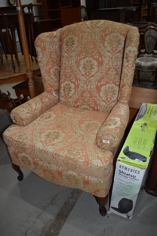 A traditional wingback armchair