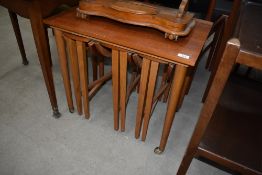 A vintage teak style nest having wheeled table approx. 62 x 42cm, nesting three smaller drop leaf