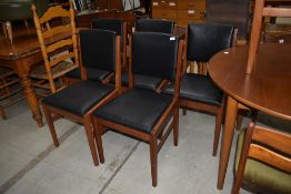 A set of five stained frame dining or office chairs having vinyl seats and backs