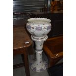 A late 19th/early 20th Century ceramic jardiniere and stand, unfortunately cracked throughout