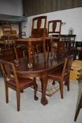 An early to mid 20th Century mahogany and stained frame oval dining table having gadrooned edge