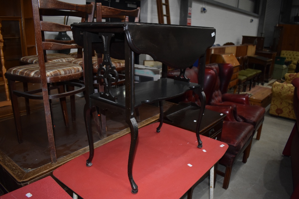 A late 19th Century Art Nouveau style dark stained occasional table having shaped drop flap and