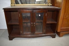 A reproduction Regency style low display unit with central display section flanked by shelves,