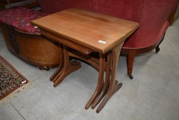 A vintage teak nest of three tables, G plan, stamped 1667, top table faded, approx. 56 x 41cm