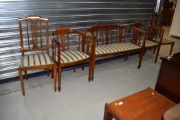 An Edwardian mahogany and inlaid salon suite, comprising settee and four (two plus two) chairs -