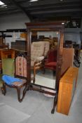 An early 20th mahogany cheval mirror in the classical style having claw feet (as found) and