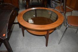 A vintage laminate and tea circular coffee table having smoked glass top, diameter approx. 84cm