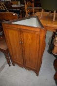 An interesting oak triangular corner cupboard having illusionary bijouterie top, possibly having