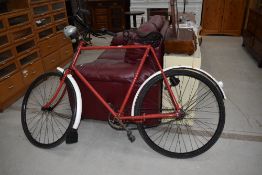 An early 20th Century (with later embellishments) push bike with sprung saddle, dynamo lights rod
