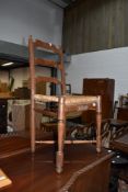 An interesting and naive style rush seated ladderback chair, having turned cross stretcher