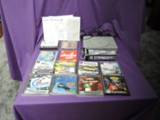 A Sony Playstation Games Console with power supply, aerial and link cable several games including