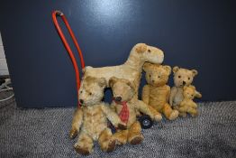 A mid 20th century Triang plush push along dog on metal frame along with five 1950's and later straw