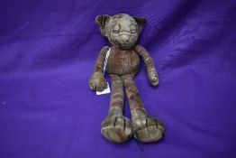 A 1930's Chad Valley Bonzo velvet soft toy having faded red body and dangling limbs, original button