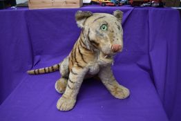 A 1960's straw filled and plush seated Lion Cub having plastic eyes, stitched nose, wooden fangs and