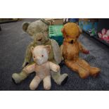 Two mid 20th century straw filed light and dark yellow plush Teddy Bears having replacement eyes,