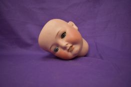 A early 20th century Heubach Koppelsdorf Bisque Head having sleep eyes and open mouth with two teeth