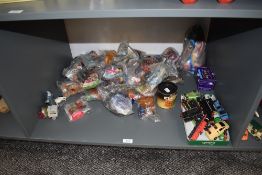 A shelf of modern toys and collectables including 1997 Mcdonalds toys, most in packets 1981 Ideal