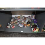 A shelf of modern toys and collectables including 1997 Mcdonalds toys, most in packets 1981 Ideal