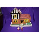 A hand made wooden Dolls House having two downstairs rooms and one bedroom along with hand made