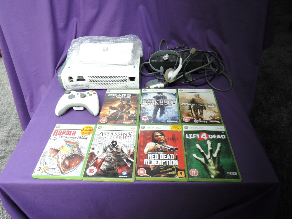 A Microsoft Xbox 360 console with one controller, power cable, head set and instruction booklet