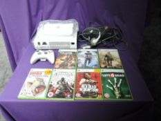 A Microsoft Xbox 360 console with one controller, power cable, head set and instruction booklet