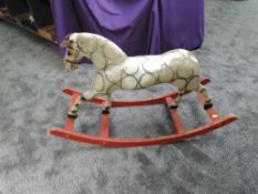 A 20th century wooden and papier mache Rocking Horse on red painted wooden rocking base