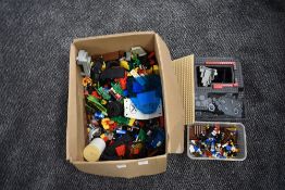 A selectuion of mixed vintage Lego pieces, figures, empty boxes and instruction booklets including