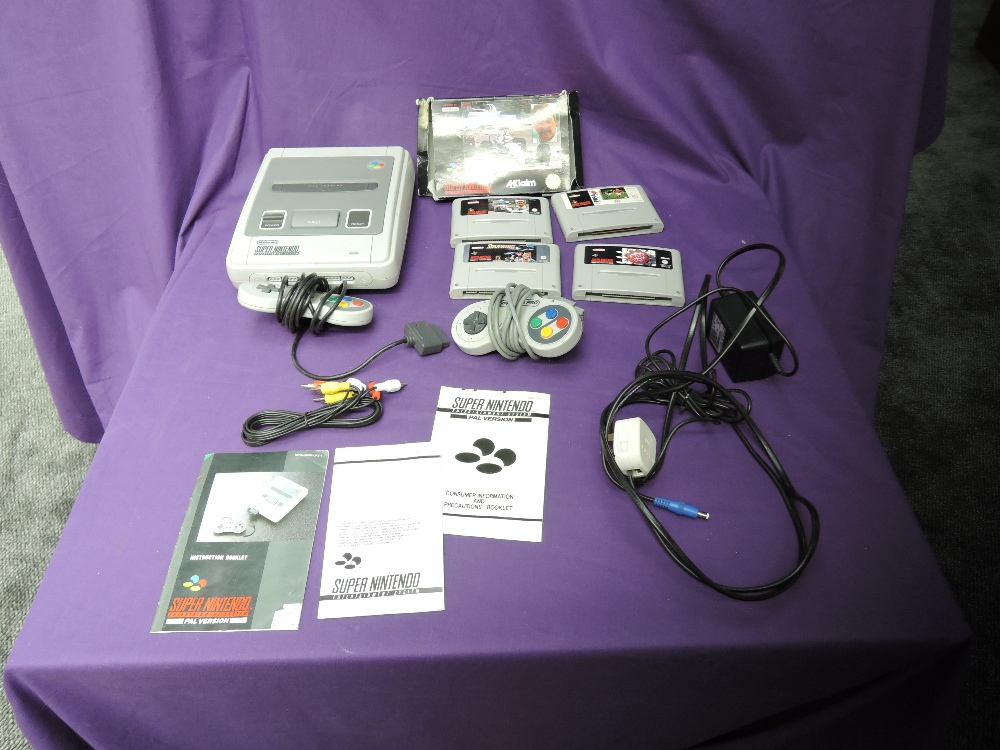 A Nintendo Super Nintendo Entertainment System with two controllers, power supply and four games,